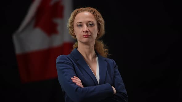 Confident Serious Canadian Politician Woman Turning to Camera Crossing Hands
