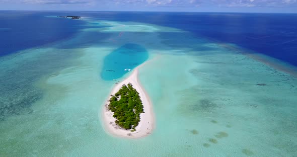 Tropical flying travel shot of a summer white paradise sand beach and aqua blue ocean background in 