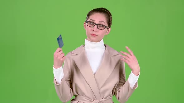 Business Lady Holding a Credit Card in Her Hands Has No Money. Green Screen