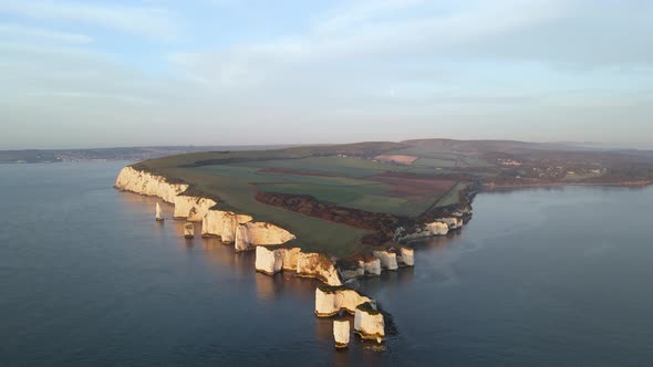 Unique aerial reverse of Old Harry Rocks cliffs illuminated by sunlight, Dorset coast, England