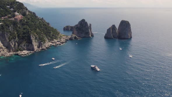 Towering rock formations on Capri coastline, Bay of Naples; aerial arc