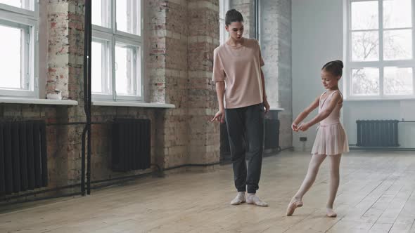 Little Ballerina Learning Ballet Pose With Trainer