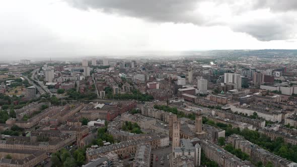 Rising dolly forward drone shot over north central Glasgow