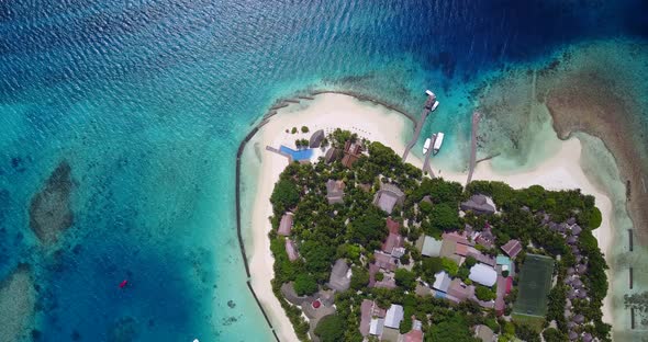 Daytime flying clean view of a white sand paradise beach and aqua blue ocean background in colourful