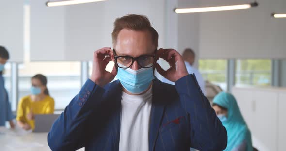 Portrait of Young Businessman at Office Wearing Protective Mask