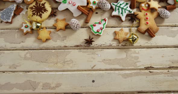 Various christmas cookies and cinnamon on a plank