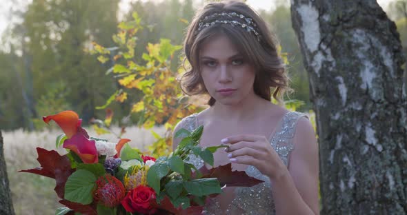 A Young Woman Dressed in a Gray Wedding Dress Celebrates Her Wedding. She Has Flowers in Her Hand