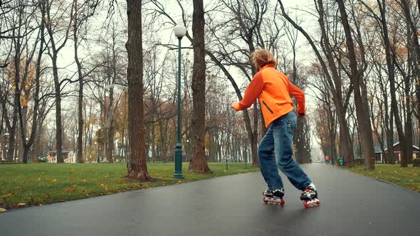 Smiling and Happy Bearded Man Enjoys Roller Skating, Makes Various Technical Turns and Feints in the