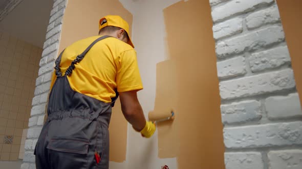 Worker Paints the Wall