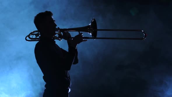 Man in Silhouette Playing on Trombone, Smoky Studio, Slow Motion
