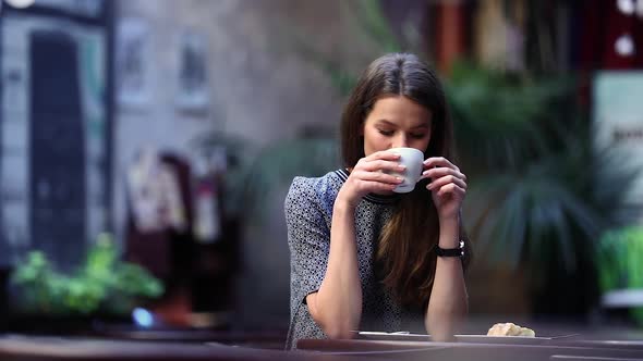 Beautiful Woman Drinking Coffee At Cafe