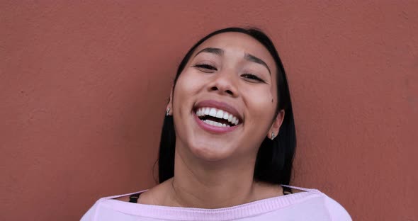 Young latin woman smiling in front of camera