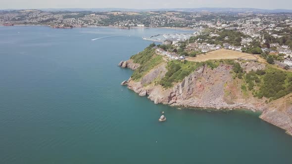 Aerial view of coastline in Torquay England. Panoramic view from the sky of beach town in southwest