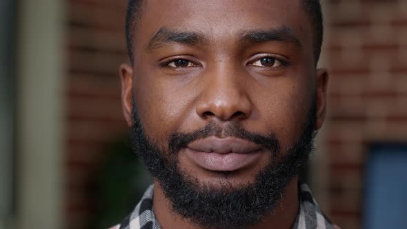 Portrait of Young Adult Showing Candid Smile in Front of Camera