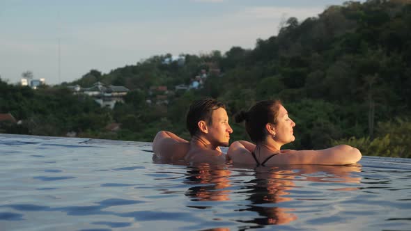 Muscular Guy Approaches Brunette Admiring Hilly Landscape