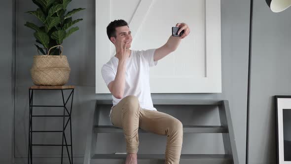 Casual Man Taking Selfie with Phone Photograph