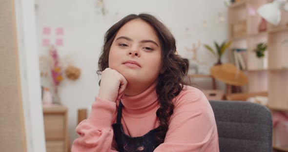 Close Up View of Beautiful Teen Sitting on Chair and Propping Her Head. Close Up View of Girl with