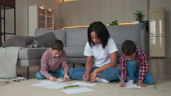 African Family Mother and Two Sons Having Fun Time at Home and Drawing Pictures