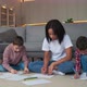 African Family Mother and Two Sons Having Fun Time at Home and Drawing Pictures - VideoHive Item for Sale