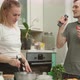 Joyful Guy Singing and Dancing Near Girlfriend Cooking in Kitchen - VideoHive Item for Sale