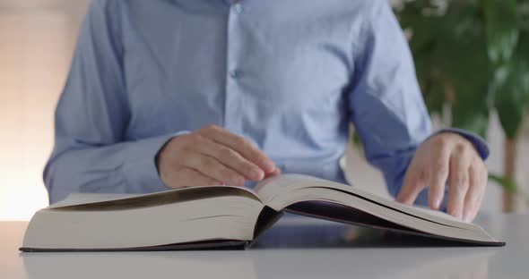 A man opens a book.