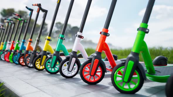 Countless colourful electric scooters standing in a row on a sunny day. 4KHD