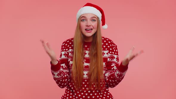 Teen Adult Girl in Christmas Hat Raising Hands in Surprise Shocked By Sudden Victory Wow Emotion