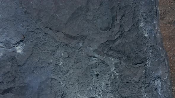 Aerial Birds Eye Overhead Top Down View of Black Lava River in Fagradalsfjall Iceland Dolly in Day