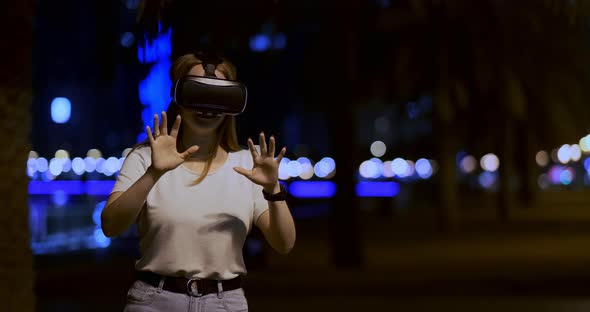 Young Girl in Virtual Reality Glasses in a Big Metropolis