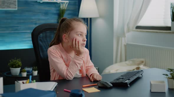 Bored Pupil Looking at Computer Screen for Online Lesson