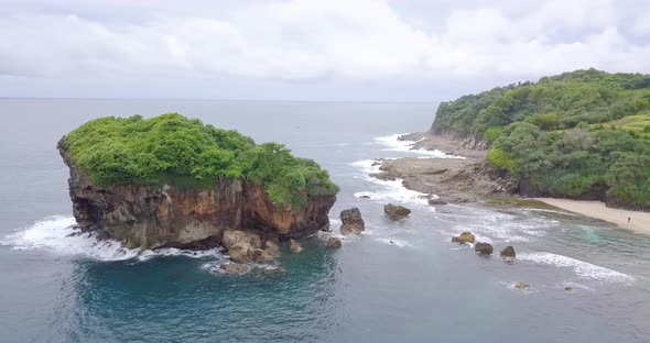 the sea water looks blue with some small rocks visible. Bird's eye view of the ocean. top view of wa