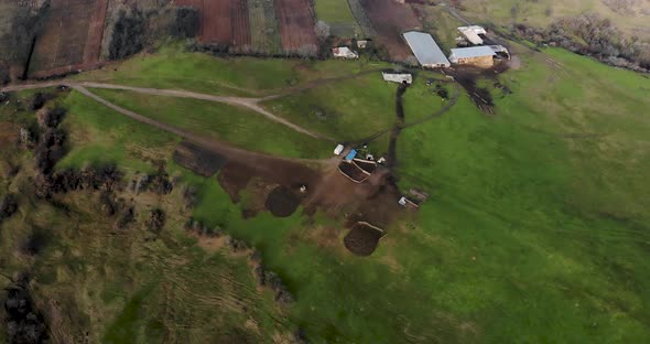 Sheepfold On Lush Green Hill In Romania - Aerial Shot