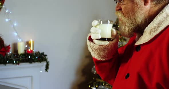 Santa claus relaxing on chair and having milk 4k