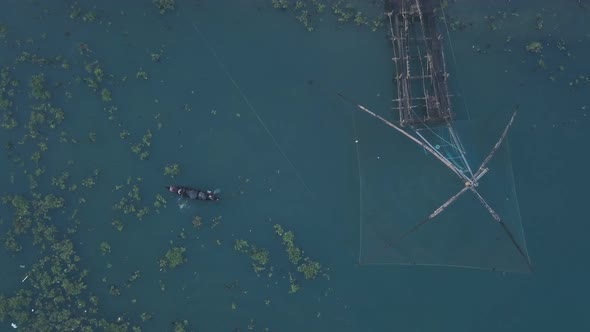 Traditional Chinese fishing nets and fishing boat at Fort Kochi, India. Top down aerial drone view