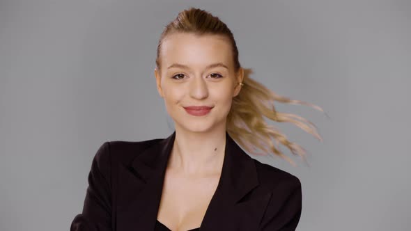 Smiling Businesswoman in Jacket Looking at Camera