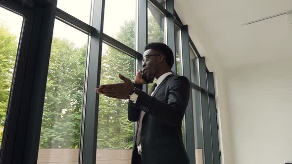 Handsome afro american businessman talking on the smartphone