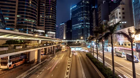 Hong Kong City Traffic After Sunset. Illuminated Street and Skyscrapers in Hong Kong at Night