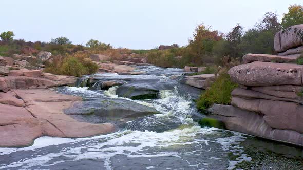 A Small Shining Stream Flows Among Smooth Wet and Dark Stones