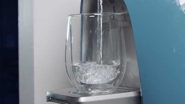 Slow motion of a water cup filling in a water filtering machine