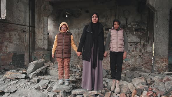 Mother with Daughters at Demolished House