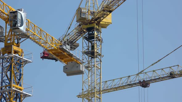 Rotating Steel Yellow Crane Over Blue Sky Background alt