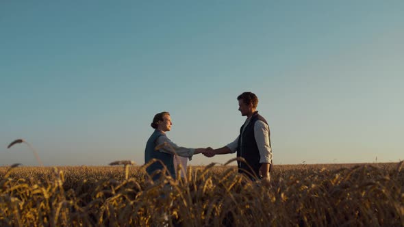 Farmers Meeting Wheat Field in Golden Sunlight