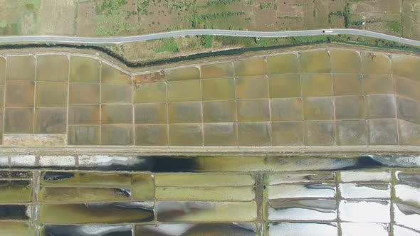 View from above of paved road passing the salt ponds on Pag island, Croatia