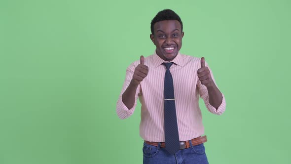 Happy Young African Businessman Looking Excited While Showing Something