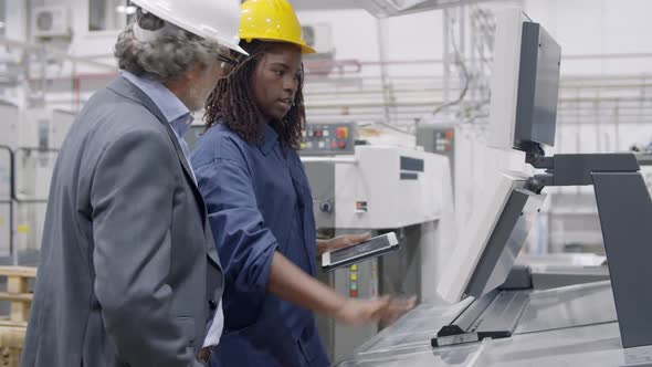 Black Female Factory Engineer Showing New Machines