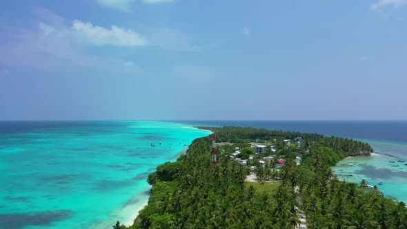 Aerial view scenery of beautiful tourist beach voyage by blue green lagoon and white sandy backgroun