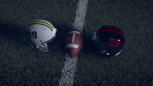 Two american football helmets and between them a ball on the field