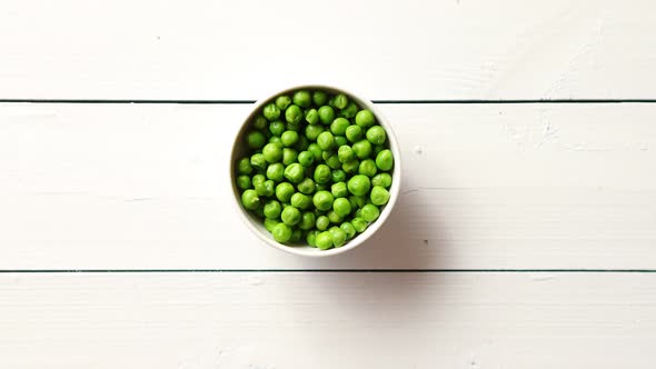 Fresh Green Pea Seeds in a White Ceramic Bowl