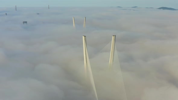 Tops of the Pylons of the Golden Bridge in the Dawn Fog in Vladivostok