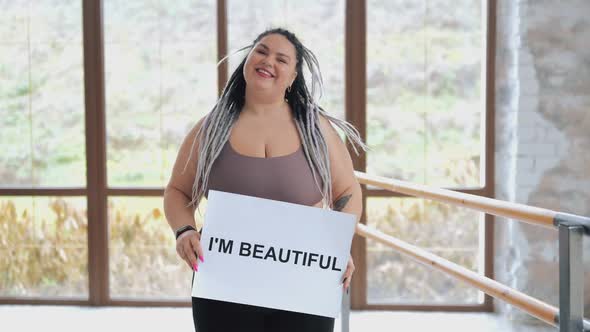 Happy Fat Woman in Underwear with Drearlocks Holding Body Positive Poster  I Love Myself